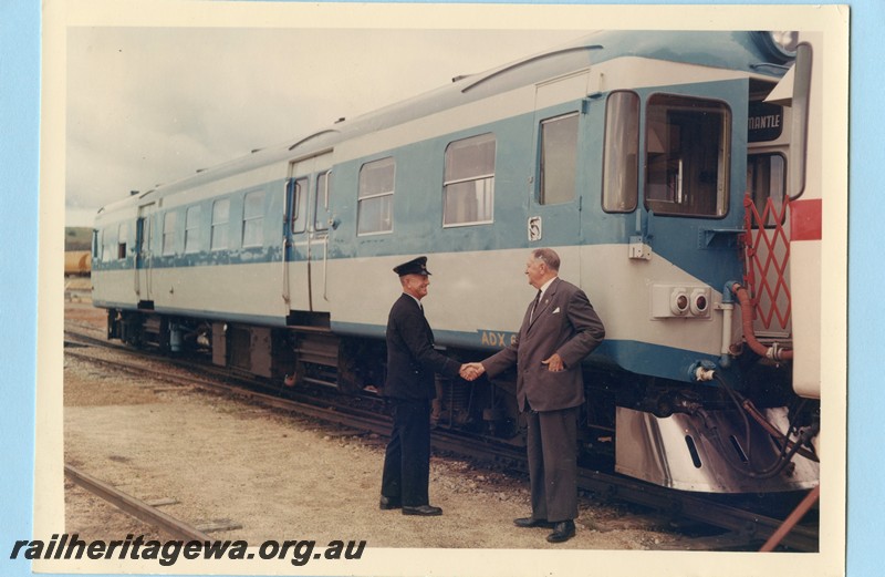 P13578
ADX class 670 in the Nanking blue and light grey livery , stainless steel cowcatcher, coupled to another railcar, Commissioner of Railways Mr. C. G. C. Wayne shaking hands with the guard, side and front view, Midland Junction, trial trip to Jumperkine. .
