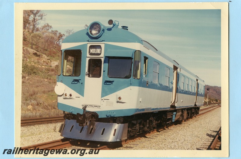 P13579
ADX class 670 in the Nanking blue and light grey livery with a stainless steel cowcatcher, missing gangways, trial run to Jumperkine, Avon Valley line, front and side view. (Ref: RIM August 1966) colour version of P00358.
