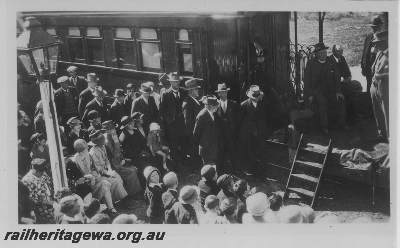 P14504
Crowd assembled in front of a platform ended carriage for the official opening of the Norseman to  Salmon Gums Railway, oil station lamp in the view, CE line 
