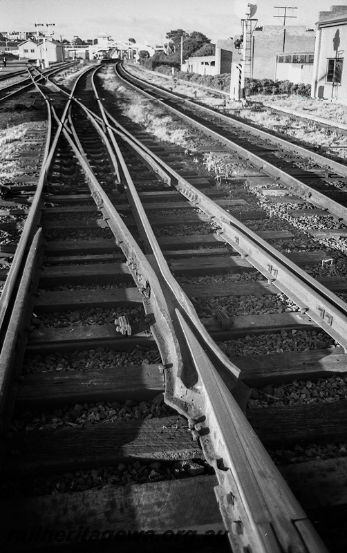 P14824
21 of 21 images of the railway precinct and station buildings at Subiaco, c1969, trackwork. Double slip, view from the west end looking east with the station in the background
