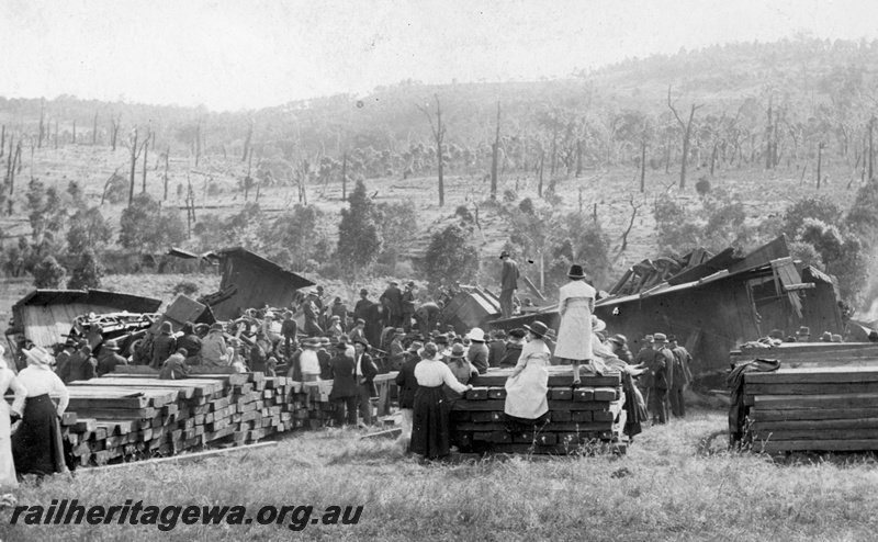 P15409
Aftermath of the Mornington Disaster, Wokalup, derailed and wrecked wagons, stacks of sleepers, many people standing around the site of the crash, phot probably taken the day after the crash as the sleepers are neatly stacked
