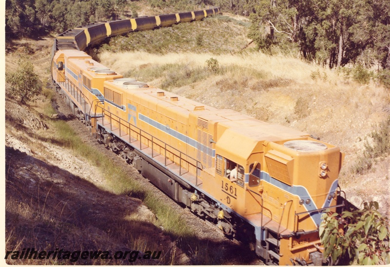 P15885
D class 1561 and another diesel loco, in Westrail orange with blue and white stripe livery, double heading a woodchip train, rural setting, front and side view taken from above 
