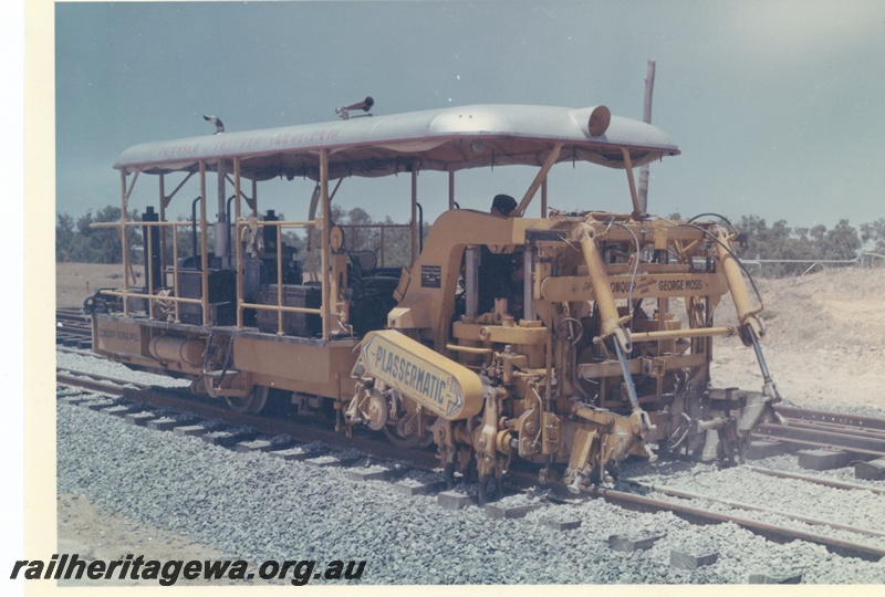 P15996
Plassermatic ballast tamper, distributed by Conquip in association with George Moss, on dual gauge track, side and front view 
