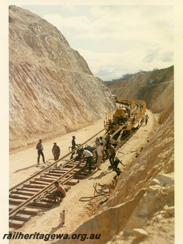P15999
Standard gauge track laying, rails, crew, wagons, diesel loco, in cutting, Windmill Hill Cutting, overview from elevated position
