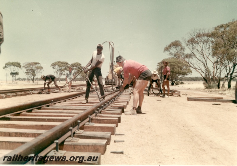 P16006
Track laying, crew at work on various tasks, rural setting, track level view
