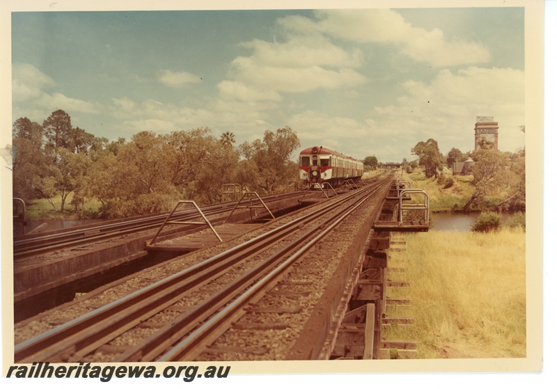 P16036
Three railcar set headed by ADG class, in red, white and green livery, crossing wooden trestle bridge over Swan River, Guildford, ER line
