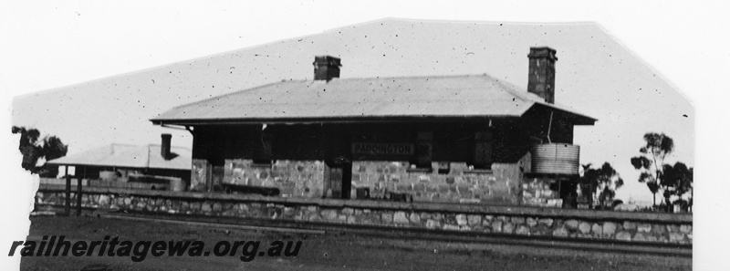 P16209
Masonry (stone) station building and platform face, water tank on the end of the building, Paddington, KL line, trackside view
