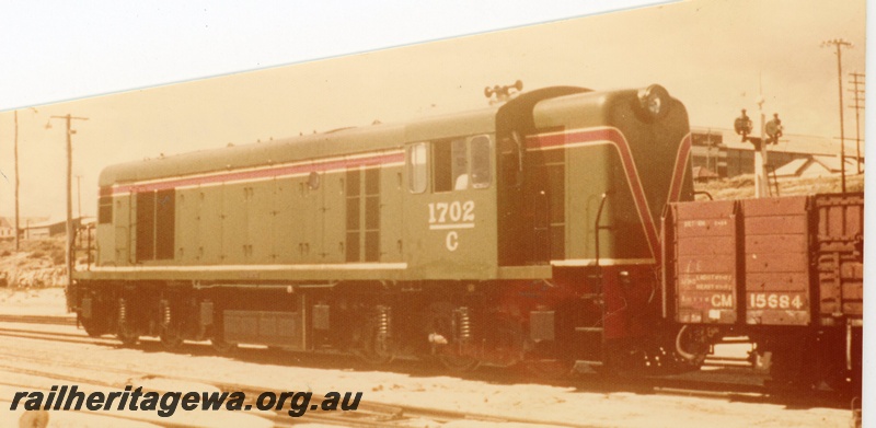 P16503
C class 1702 in green with red and white stripe, GM class 15684 wagon (part), signal, side and end view
