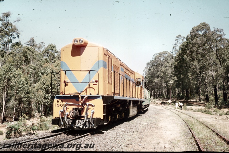 P16680
RA class 1908, in Westrail orange with blue stripe livery, long hood leading, ARHS tour train to Fernbrook, green and cream carriages, passengers on track, Beela, BN line, bush setting, front  and side view
