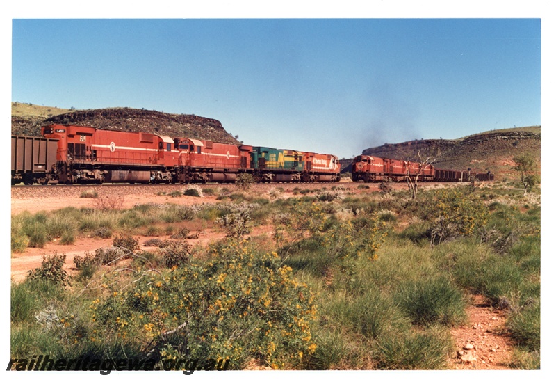 P16757
Mount Newman (MNM) M636 class 5502, 5488 (bi centennial livery), 5472, 5490 cross a 192 car loaded train at Garden loop.
