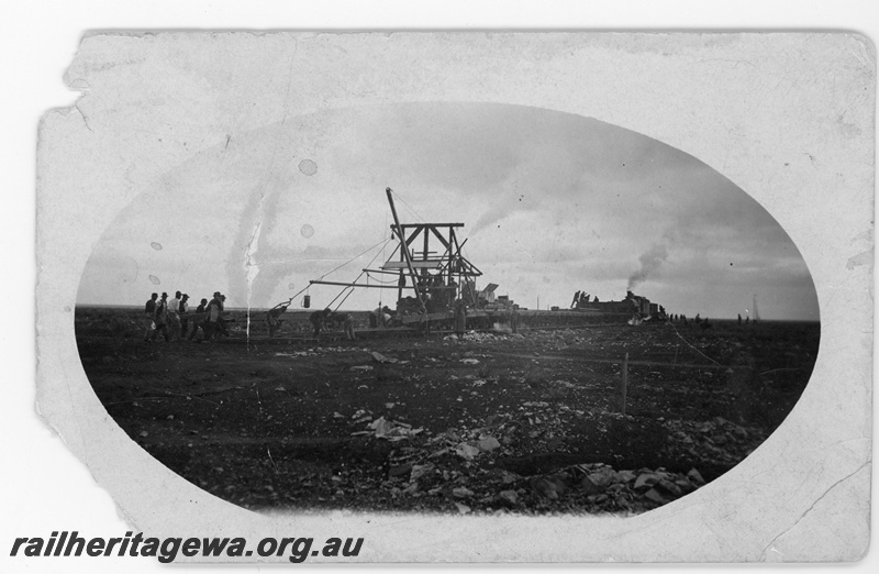 P16806
Commonwealth Railways (CR) - TAR line track laying machine with G class locomotive in background. c1916
