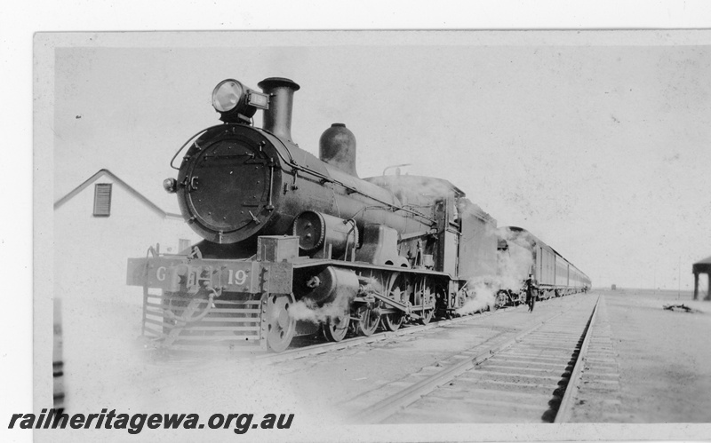 P16879
Commonwealth Railways (CR) - TAR line G class 19 steam locomotive hauling Transcontinental express at an Unknown location.
