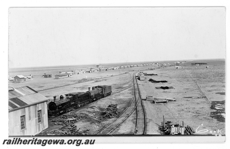 P16887
Commonwealth Railways (CR) - TAR line Cook locomotive depot with K class 50 steam locomotive. 
