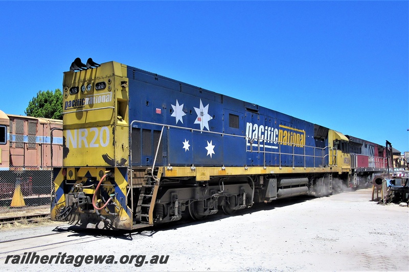 P16893
Pacific National loco, NR class 20, leading MRL class 005 through the site of the Rail Transport Museum, Bassendean, long hood leading
