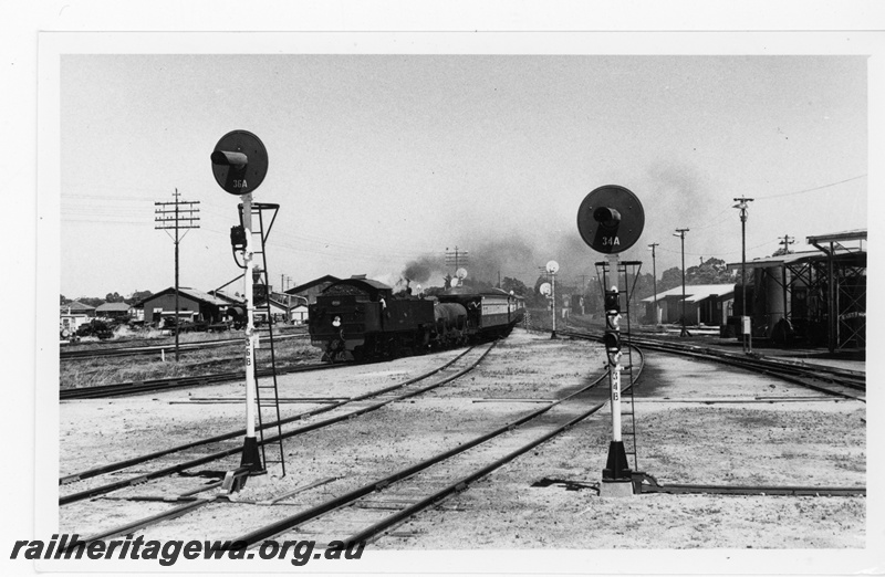 P16929
DM Class 586 approaches Midland Station hauling ARHS tour train to Gingin. Colour light signals in photo and Midland diesel locomotive depot on right of photo. ER line.
