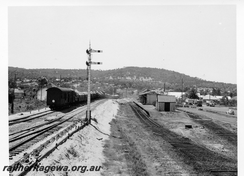 P17123
Old station, tracks partly removed, bracket signal, eastbound goods train heading away from camera, Bellevue, ER line, c1966
