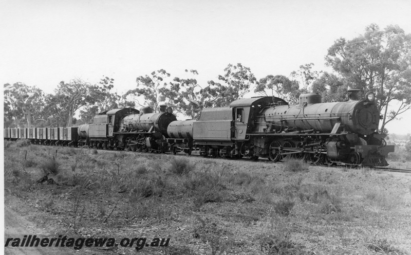 P17377
W class 919, W class 914 steam locomotives at the head of 54 Goods leaving Duranillin. WB line. Front view of leading loco and side views of both locomotives.
