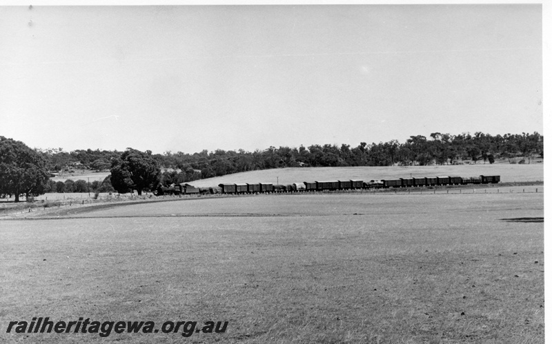 P17390
PMR class 713 steam locomotive on 108 Goods from Narrogin to Collie. Location Unknown. BN line. Distant view of entire train.

