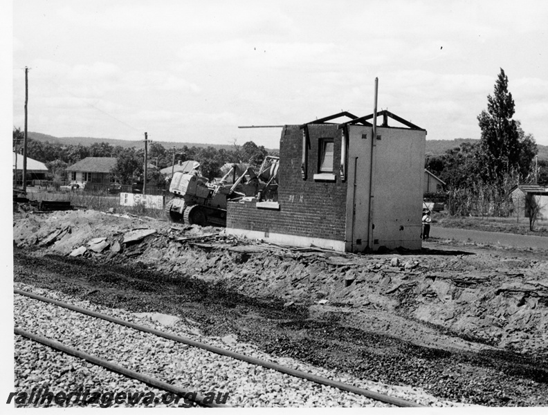 P17602
Another view of the demolition of Bellevue station. ER line, Tracked excavator near building remains. Standard gauge track in foreground.
