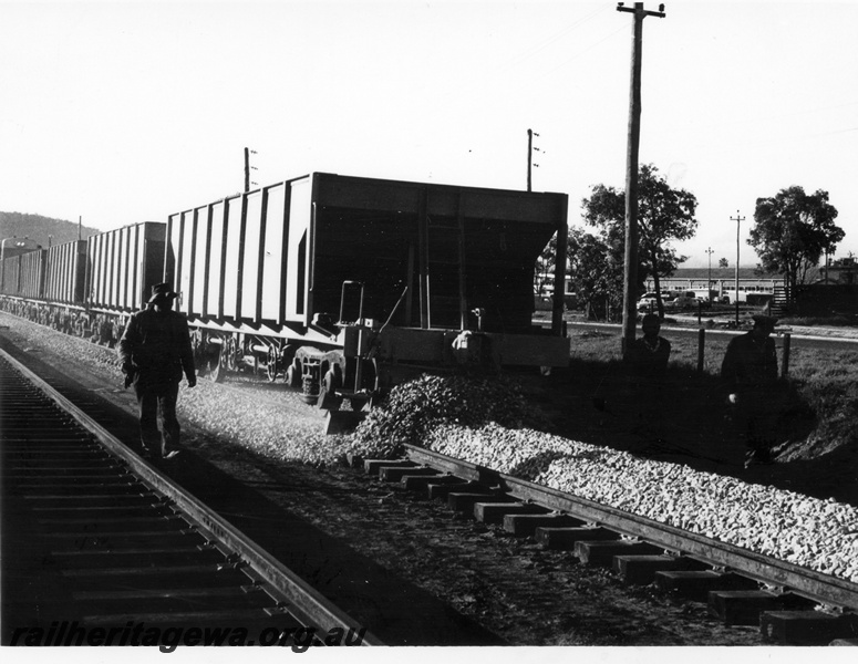 P17874
A rake of WSH standard gauge ballast hoppers unloading/ploughing ballast. Location Unknown.

