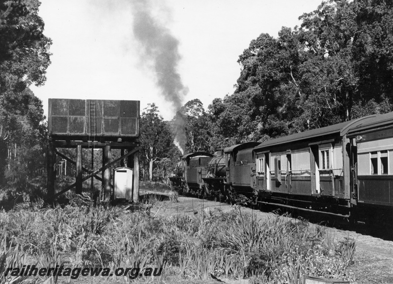 P18103
W class 908 & W class 927 steam locomotives at the head of a RESO train at Cambray. WN line. Water tower  with a 25,000 gallon cast iron tank  with pump house beneath,  side on view of the tank and view along the train. See also P17545
