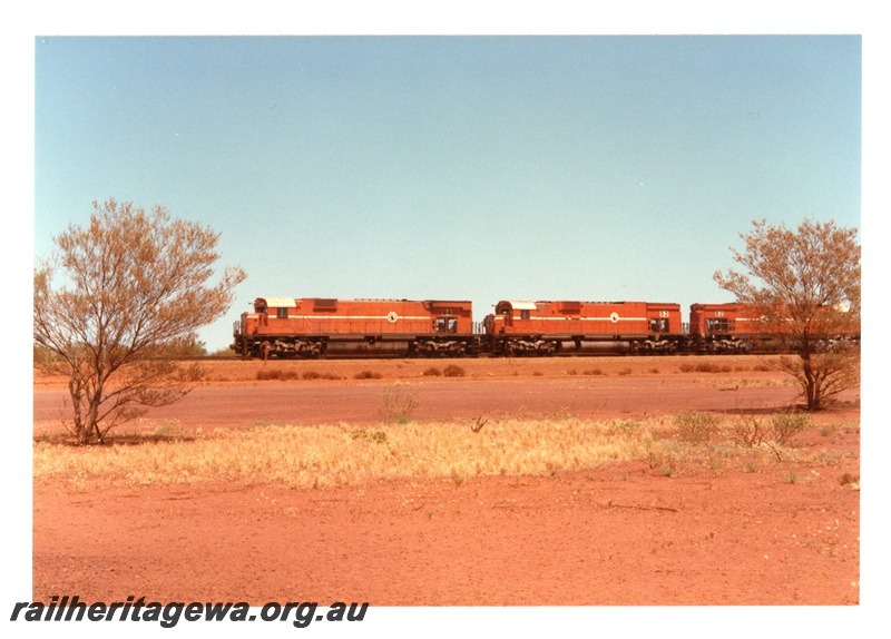 P18732
Mount Newman (MNM) M636 class 5497, C636 class 5452, C636 class 5462 haul empty ore train through Poonda.
