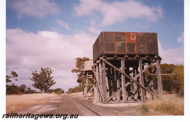 P18998
Two adjacent Water towers, one with a 25,000 gallon cast iron tank and the other with a cylindrical corrugated iron tank, Kwobrup, KP line, trackside and end view.
