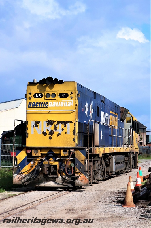 P19307
Pacific National NR class 41, yellow and blue livery, passing through the site of the Rail Transport Museum enroute to UGL plant, Bassendean, end and side view
