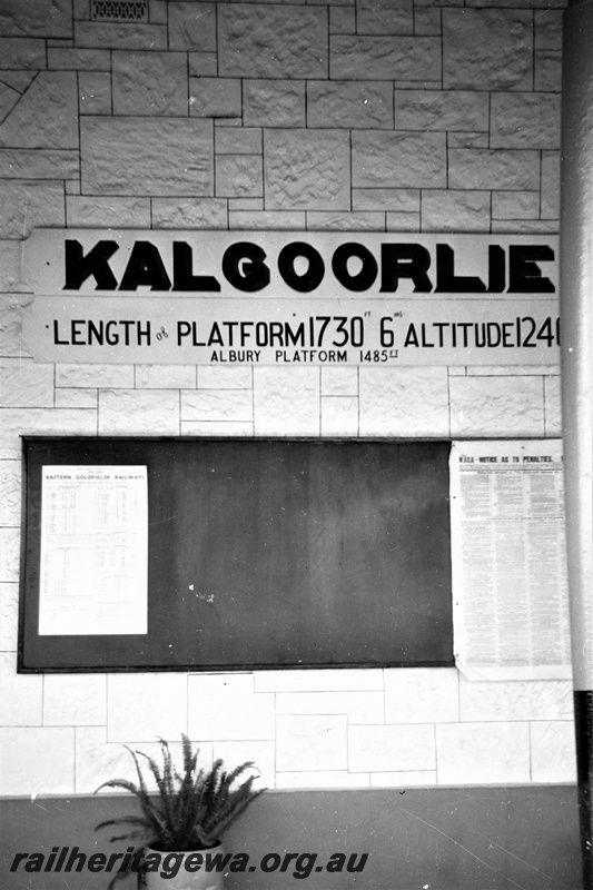 P19517
Station nameboard, showing platform length compared to Albury, noticeboard, plant, Kalgoorlie, EGR line

