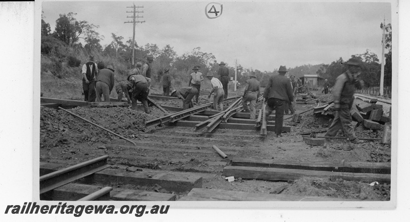 P19655
3 of 5 images of the installation of a double compound (double slip) at Parkerville, ER line. Images 1 & 2 in the sequence are numbered P01052 & P01053. This image, taken at 11am, shows the pointwork in position ready to lower onto the formation
