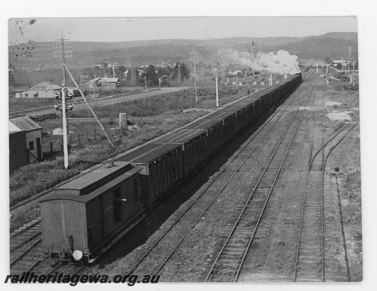 P19658
A stock train being hauled by a steam loco heading east between Midland Junction and Bellevue, ER line, a clerestory roofed Z Class brakevan, elevated view from the rear of the train looking eastwards
