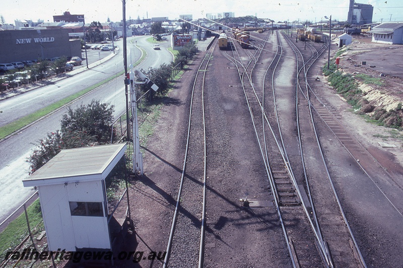 P19811
Shelter shed over a lever frame, rear view of a sommersault signal, elevated view of the yard looking west, Bunbury, SWR line 
