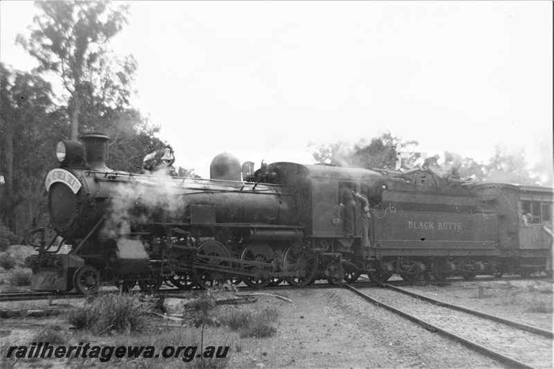 P20025
Hawker Sidderley Building Supplies loco, ex WAGR CS class 270, Black Butte on the Banksiadale timber mill line crossing over the PN line, Wuraming, AA class 206 first class carriage and two R class wagons with passengers behind the loco, ARHS tour train , the train straddling the crossing,  front and side view of the loco

