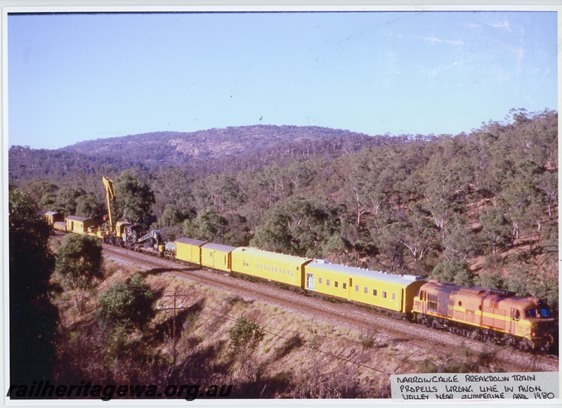 P20037
X class 1025 in the International Safety orange livery, propelling breakdown train which includes breakdown cranes No. 23 and No.  31 to Jumperkine due to a derailment including yellow cars, vans, mobile cranes, on wrong line - down main, Avon Valley line, side and end view
