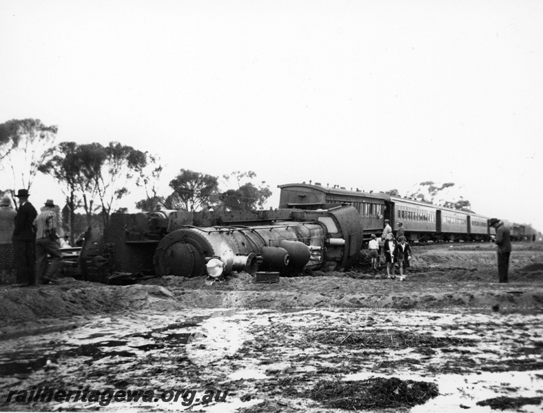 P20120
P class 444 on No. 8 Albany express derailed and laying on its side between Highbury and Narrogin,on the 23rd of January, 1939, GSR line, passenger carriages, onlookers, front and side view
