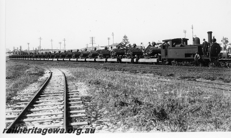 P20137
B class 13, on goods train loaded with harvesters from State Implement Works, North Fremantle, ER line
