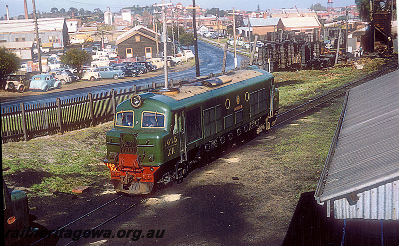 P20422
XA Class 1405 in all green livery with cream roof at East Perth locomotive depot. East Parade in background showing industries in East Perth at time photograph taken. ER line.
