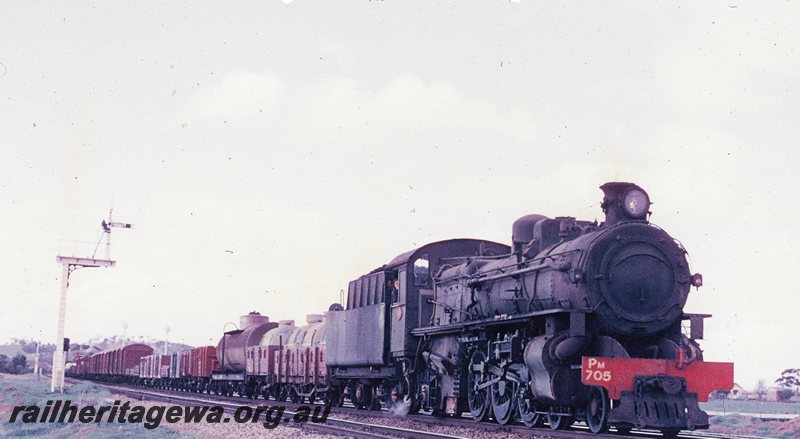 P20766
PM class 705 number 104 goods from Merredin approaches East Northam. The first 2 wagons behind the locomotive loaded with tanks of wine transhipped at the Parkeston interchange. Home and distant signals in photo. EGR line.
