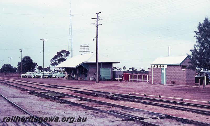 P20781
Parkeston station building, sign and toilet building. Numerous Holden cars parked alongside station building. EGR line. 
