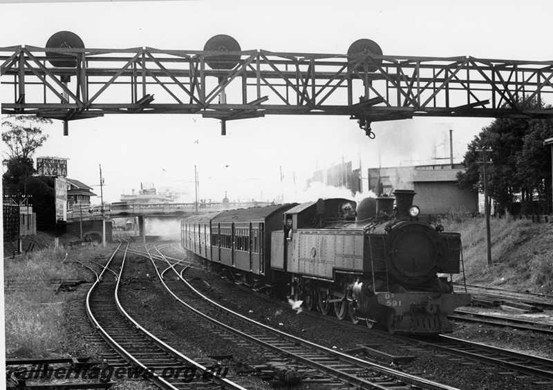 P20822
DD class 591, on Midland-bound passenger train comprising AYB class carriage behind the locomotive and AY class carriages, overhead road bridge, signal box, gantry signals, departing Perth station, ER line, side and front view
