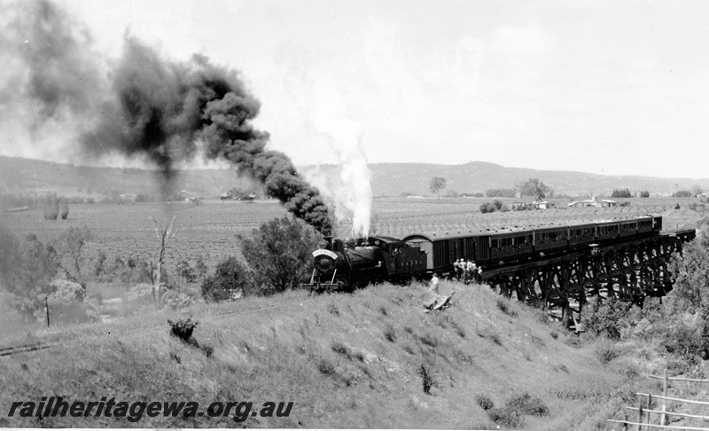 P20832
Midland Railway Co C class 18, on tour train to Mooliabeenie, group of sight seers, on wooden trestle bridge over Swan River at Upper Swan, MR line, front and side view

