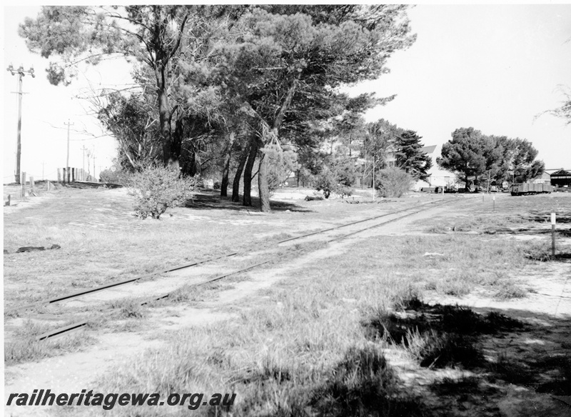 P20835
Site of the proposed Railway Museum, when originally handed over to the Australian Railway Historical Society Inc (WA Division), single track, trees, fence, industrial buildings, Bassendean, ER line
