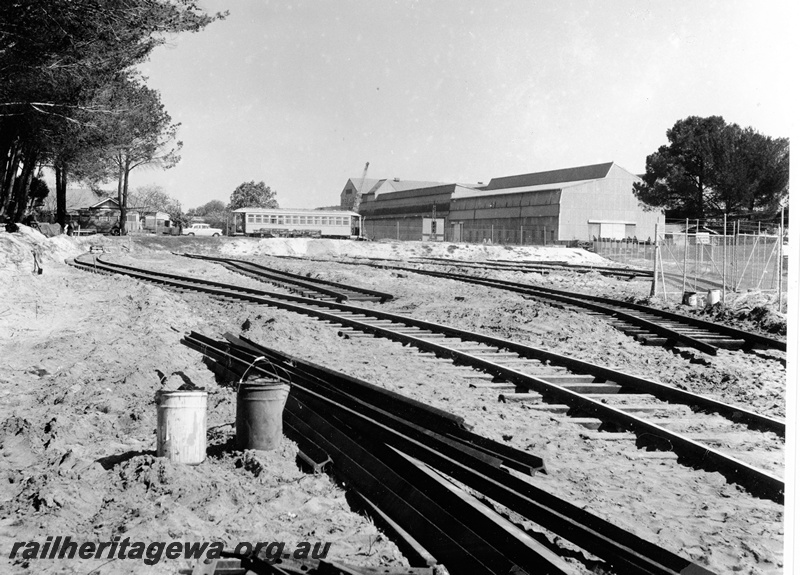 P20838
Track laying in progress at proposed Railway Museum site, tracks, trees, car, carriage, industrial building, Bassendean, ER line
