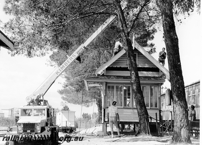 P20840
Signal box being lifted into position, by Kimbers mobile crane, carriages, workers, trees, Railway Museum site, Bassendean, ER line, ground level view 
