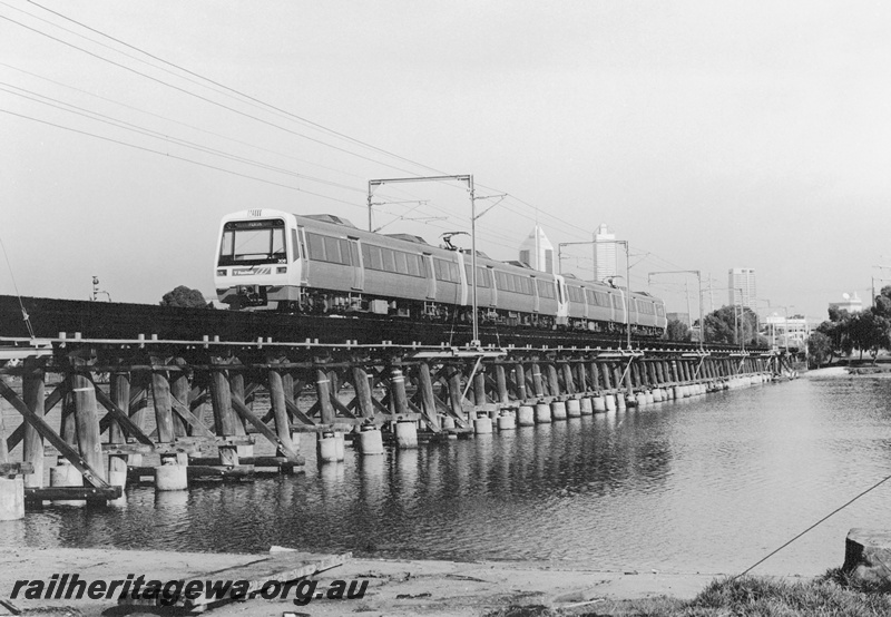 P20868
AEB class 308 EMU trailer car heads a four car set over the Bunbury Bridge, SWR line, towards Armadale, view of the train on the bridge
