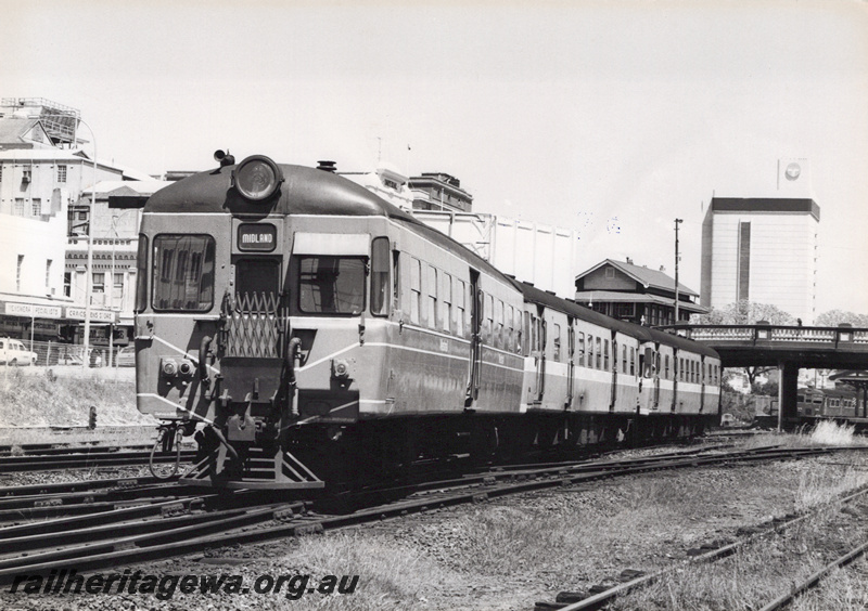 P20870
ADA class railcar trailer leading a three car railcar set eastwards out of Perth, Barrack street Bridge and Box C in the background

