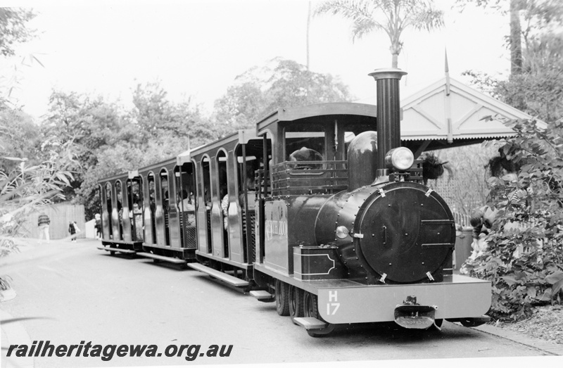P20875
Replica WAGR H class internal engined rubber tyred  loco numbered H17 hauling three toast rack styled carriages, Perth Zoo, side and front view of the loco and train.
