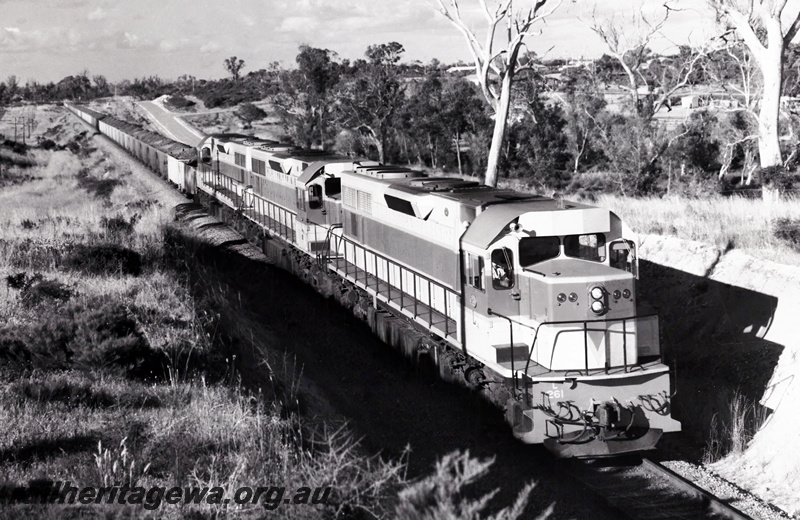 P20897
L class 261 leads 2 other L class hauling a loaded iron ore train near Kwinana. 
