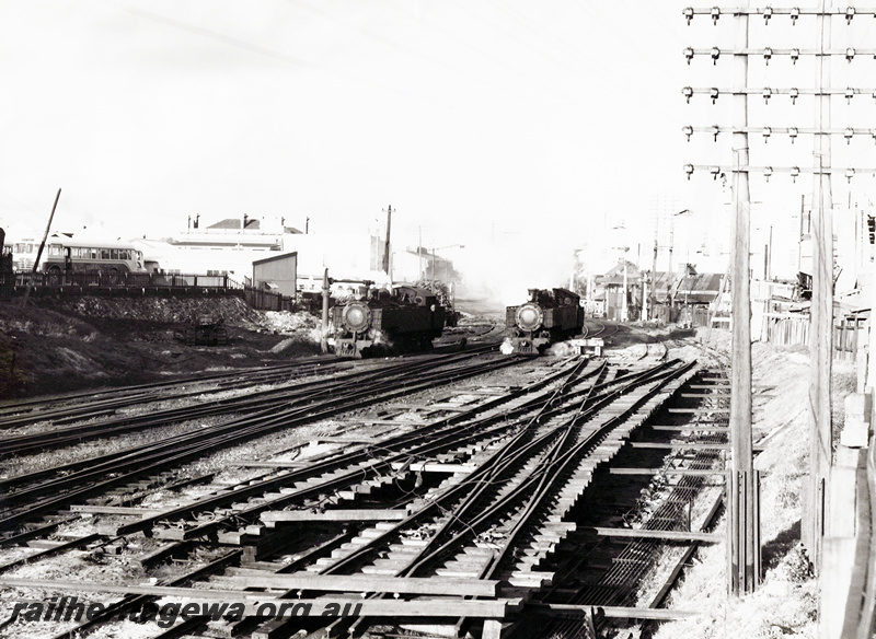 P20913
DD class loco taking on water, another DD class loco, signals, Moore St signal box, scissors crossover with double slips trackwork, industrial buildings, Perth, ER line, front and side view from track level
