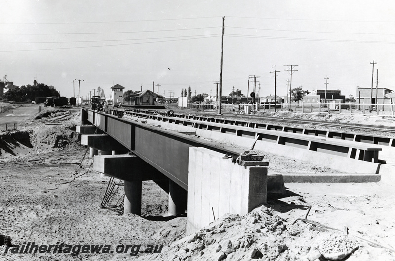 P20928
Steel girder with concrete pylons rail bridge over Great Eastern Highway, Rivervale, SWR line, signal box and station buildings in the background, view along the bridge looking towards Perth
